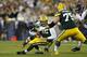 GREEN BAY, WI - SEPTEMBER 13: Aaron Rodgers #12 of the Green Bay Packers gets sacked by Henry Melton #69 of the Chicago Bears during first half play at Lambeau Field on September 13, 2012 in Green Bay, Wisconsin. (Photo by Joe Robbins/Getty Images)
