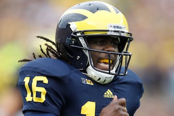 Denard Robinson takes a licking, but keeps on ticking.