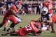 SALT LAKE CITY, UT - SEPTEMBER 15: Quarterback Riley Nelson #13 of the BYU Cougars is tackled after a small gain by Tyron Morris-Edwards #27 of the University of Utah Utes as LT Filiaga #42 gives chase during the first half of a college football game September 15, 2012 at Rice Eccles Stadium in Salt Lake City, Utah. (Photo by George Frey/Getty Images)