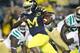 ANN ARBOR, MI - SEPTEMBER 10: Denard Robinson #16 of the Michigan Wolverines looks for yards on a fourth quarter run while playing the Notre Dame Fighting Irish at Michigan Stadium on September 10, 2010 in Ann Arbor, Michigan. Michigan won the game 35-31.(Photo by Gregory Shamus/Getty Images)