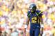 LANDOVER, MD - SEPTEMBER 15: Geno Smith #12 of the West Virginia Mountaineers reacts after a play against the James Madison Dukes during a game at FedExField on September 15, 2012 in Landover, Maryland. (Photo by Patrick McDermott/Getty Images)