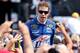JOLIET, IL - SEPTEMBER 16: Brad Keselowski, driver of the #2 Miller Lite Dodge, greets fans during driver introductions prior to the start of the NASCAR Sprint Cup Series GEICO 400 at Chicagoland Speedway on September 16, 2012 in Joliet, Illinois. (Photo by Jonathan Daniel/Getty Images for NASCAR)