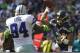 SEATTLE, WA - SEPTEMBER 16: Russell Wilson #3, right, of the Seattle Seahawks passes the ball as DeMarcus Ware #94 of the Dallas Cowboys rushes during a game at CenturyLink Field on September 16, 2012 in Seattle, Washington. (Photo by Stephen Brashear/Getty Images)