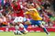 LONDON, ENGLAND - SEPTEMBER 15: Lukas Podolski of Arsenal and James Ward-Prowse of Southhampton battle for the ball during the Barclays Premier League match between Arsenal and Southampton at Emirates Stadium on September 15, 2012 in London, England. (Photo by Clive Mason/Getty Images)