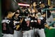 WASHINGTON, DC - AUGUST 03: Jose Reyes #7 of the Miami Marlins celebrates with his teammates after scoring a run against the Washington Nationals at Nationals Park on August 3, 2012 in Washington, DC. (Photo by Patrick McDermott/Getty Images)