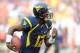 LANDOVER, MD - SEPTEMBER 15: Geno Smith #12 of the West Virginia Mountaineers runs the ball against the James Madison Dukes during a game at FedExField on September 15, 2012 in Landover, Maryland. (Photo by Patrick McDermott/Getty Images)