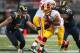 ST. LOUIS, MO - SEPTEMBER 16: Chris Long #91 of the St. Louis Rams looks to tackle Evan Royster #22 of the Washington Redskins at the Edward Jones Dome on September 16, 2012 in St. Louis, Missouri. (Photo by Dilip Vishwanat/Getty Images)