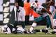 Dec 12 2010; East Rutherford, NJ, USA; New York Jets quarterback Mark Sanchez (6) lays on the ground after missing the fourth down conversion while Miami Dolphins linebacker Cameron Wake (91) celebrates during the second half at the New Meadowlands Stadium. Mandatory Credit: Alan Maglaque-US PRESSWIRE