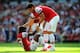 LONDON, ENGLAND - AUGUST 18: Olivier Giroud of Arsenal helps Gervinho of Arsenal off the ground during the Barclays Premier League match between Arsenal and Sunderland at Emirates Stadium on August 18, 2012 in London, England. (Photo by Mike Hewitt/Getty Images)