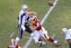 Dec 11, 2011; Landover, MD, USA; New England Patriots quarterback Tom Brady (12) passes as he is hit by Washington Redskins linebacker Ryan Kerrigan (91) in the second quarter at FedEx Field. New England won 34-27. Mandatory Credit: James Lang-US PRESSWIRE