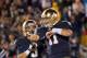 Sep 22, 2012; South Bend, IN, USA; Notre Dame Fighting Irish quarterback Tommy Rees (11) celebrates his second quarter touchdown with wide receiver Robby Toma (9) against the Michigan Wolverines at Notre Dame Stadium. Mandatory Credit: Matt Cashore-US PRESSWIRE