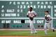 BOSTON, MA - SEPTEMBER 22: Adam Jones #10 and Nate McLouth #9 of the Baltimore Orioles celebrate a 9-6 win in the 12th inning against the Boston Red Sox at Fenway Park on September 22, 2012 in Boston, Massachusetts. (Photo by Jim Rogash/Getty Images)