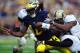 Oct 29, 2011; Ann Arbor, MI, USA; Michigan Wolverines quarterback Denard Robinson (16) is tackled as he runs the ball during the second quarter against the Purdue Boilermakers at Michigan Stadium. Mandatory Credit: Andrew Weber-US