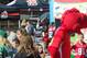 Beyond the fans and mascot dinosaurs sits the Grey Cup, on display (Photo: Jim Flannery)