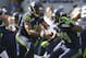 SEATTLE, WA - SEPTEMBER 16: Quarterback Russell Wilson #3 of the Seattle Seahawks drops back to pass during a game against the Dallas Cowboys at CenturyLink Field on September 16, 2012 in Seattle, Washington. At right is Marshawn Lynch #24. (Photo by Stephen Brashear/Getty Images)