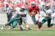 COLUMBUS, OH - SEPTEMBER 22: Braxton Miller #5 of the Ohio State Buckeyes slips past Greg Irvin #7 and Lamarcus Farmer #3, both of the University of Alabama at Birmingham Blazers, during the second quarter on September 22, 2012 at Ohio Stadium in Columbus, Ohio. (Photo by Kirk Irwin/Getty Images)