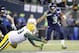 Russell Wilson stiff arms a defender in the Seahawks' Monday night victory over the Green Bay Packers