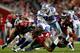 TAMPA, FL - DECEMBER 17: Running back Felix Jones #28 of the Dallas Cowboys is tackled by defenders Tanard Jackson #36 and Adrian Clayborn #94 of the Tampa Bay Buccaneers during the game at Raymond James Stadium on December 17, 2011 in Tampa, Florida. (Photo by J. Meric/Getty Images)