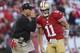 SAN FRANCISCO, CA - SEPTEMBER 16: Head coach Jim Harbaugh of the San Francisco 49ers gives his quarterback Alex Smith a play to run in the second quarter against the Detroit Lions at Candlestick Park on September 16, 2012 in San Francisco, California. (Photo by Thearon W. Henderson/Getty Images)