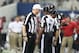 Sep 23, 2012; Arlington, TX, USA; Replacement referee Robert Dalton (22) talks with back judge Bobby Jackson (56) and side judge Jeff Garvin (38) for a penalty flag during the game with the Dallas Cowboys against the Tampa Bay Buccaneers at Cowboys Stadium. Mandatory Credit: Matthew Emmons-US PRESSWIRE