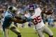 Sep 20, 2012; Charlotte, NC, USA; New York Giants running back Andre Brown (35) runs as Carolina Panthers cornerback Josh Norman (24) defends during the second quarter at Bank of America Stadium. Mandatory Credit: Bob Donnan-US PRESSWIRE