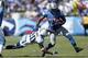 NASHVILLE, TN - SEPTEMBER 23: Alterraun Verner #20 of the Tennessee Titans makes a tackle against Mikel Leshoure #25 of the Detroit Lions during the game at LP Field on September 23, 2012 in Nashville, Tennessee. (Photo by Joe Robbins/Getty Images)