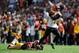 LANDOVER, MD - SEPTEMBER 23: Andrew Hawkins #16 of the Cincinnati Bengals avoids the tackle of Richard Crawford #39 of the Washington Redskins on his way to scoring the game-winning touchdown on a pass from Andy Dalton #14 in the fourth quarter at FedExField on September 23, 2012 in Landover, Maryland. The Cincinnati Bengals defeated the Washington Redskins 38-31. (Photo by Patrick McDermott/Getty Images)