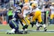 Sep 24, 2012; Seattle, WA, USA; Green Bay Packers quarterback Aaron Rodgers (12) is sacked by Seattle Seahawks defensive end Bruce Irvin (51) during the 1st half at CenturyLink Field. Mandatory Credit: Steven Bisig-US PRESSWIRE