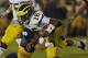 SOUTH BEND, IN - SEPTEMBER 22: Denard Robinson #16 of the Michigan Wolverines is hit by Bennett Jackson #2 of the Notre Dame Fighting Irish at Notre Dame Stadium on September 22, 2012 in South Bend, Indiana. Notre Dame defeated Michigan 13-6. (Photo by Jonathan Daniel/Getty Images)