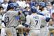 SAN DIEGO, CA - SEPTEMBER 26: Matt Kemp #27 of the Los Angeles Dodgers, right, is congratulated by Adrian Gonzalez #23, left, and Nick Punto #7, center, after he hit a two-run homer during the sixth inning of a baseball game against the San Diego Padres at Petco Park on September 26, 2012 in San Diego, California. (Photo by Denis Poroy/Getty Images)