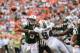 Sept 23, 2012; Miami, FL, USA; New York Jets quarterback Mark Sanchez (6) is pressured by Miami Dolphins defensive tackle Randy Starks (94) during the second half at Sun Life Stadium. The Jets won 23-20 in overtime. Mandatory Credit: Steve Mitchell-US PRESSWIRE