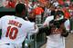 BALTIMORE, MD - SEPTEMBER 13: Adam Jones #10 hits teammate Manny Machado #13 of the Baltimore Orioles with a shaving cream pie after Machado drove in Jones for the game winning run to give the Orioles a 3-2 win over the Tampa Bay Rays in fourteen innings at Oriole Park at Camden Yards on September 13, 2012 in Baltimore, Maryland. (Photo by Rob Carr/Getty Images)