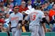 BOSTON, MA - SEPTEMBER 22: Manny Machado #13 and Chris Davis #19 of the Baltimore Orioles celebrate with J.J. Hardy #2 after scoring in the sixth inning against the Boston Red Sox at Fenway Park on September 22, 2012 in Boston, Massachusetts. (Photo by Jim Rogash/Getty Images)