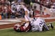 Sep 22, 2012; Norman, OK, USA; Oklahoma Sooner quarterback Landry Jones (12) has the ball knocked out of his hands by Kansas State Wildcats linebacker Justin Tuggle (2) and Jarrell Childs (26) recovered the fumble for a touchdown in the second quarter at Oklahoma Memorial Stadium. Mandatory Credit: Matthew Emmons-US PRESSWIRE