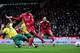 NORWICH, ENGLAND - APRIL 28: Luis Suarez of Liverpool takes a shot on goal as Bradley Johnson of Norwich slides in during the Barclays Premier League match between Norwich City and Liverpool at Carrow Road on April 28, 2012 in Norwich, England. (Photo by Jamie McDonald/Getty Images)