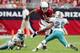 GLENDALE, AZ - SEPTEMBER 14: Larry Fitzgerald #11 of the Arizona Cardinals carries the ball in the first half against Chris Crocker #20 of the Miami Dolphins at University of Phoenix Stadium on September 14, 2008 in Glendale, Arizona. (Photo by Lisa Blumenfeld/Getty Images)