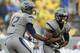 MORGANTOWN, WV - SEPTEMBER 22: Geno Smith #12 of the West Virginia Mountaineers hands the ball off to Tavon Austin #1 against the Maryland Terrapins during the game on September 22, 2012 at Mountaineer Field in Morgantown, West Virginia. WVU defeated Maryland 31-21. (Photo by Justin K. Aller/Getty Images)