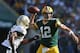 GREEN BAY, WI - SEPTEMBER 30: Quarterback Aaron Rodgers #12 of the Green Bay Packers is defended by cornerback Corey White #24 of the New Orleans Saints in the first half at Lambeau Field on September 30, 2012 in Green Bay, Wisconsin. (Photo by Jeff Gross/Getty Images)