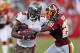 TAMPA, FL - SEPTEMBER 30: Receiver Mike Williams #19 of the Tampa Bay Buccaneers is tackled by defender Josh Wilson #26 of the Washington Redskins during the game at Raymond James Stadium on September 30, 2012 in Tampa, Florida. (Photo by J. Meric/Getty Images)