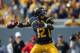 September 29, 2012; Morgantown, WV, USA; West Virginia Mountaineers quarterback Geno Smith (12) drops back to pass in the first quarter in the game against the Baylor Bears at Milan Puskar Stadium. Mandatory Credit: Rob Christy-US PRESSWIRE