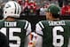 Tebow and Sanchez watch from the sideline during Sunday's game aginst the 49ers