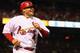 ST. LOUIS, MO - OCTOBER 1: Yadier Molina #4 of the St. Louis Cardinals returns to the dugout after scoring a run against the Cincinnati Reds at Busch Stadium on October 1, 2012 in St. Louis, Missouri. (Photo by Dilip Vishwanat/Getty Images)