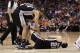 PHOENIX, AZ - APRIL 13: Manu Ginobili #20 of the San Antonio Spurs lays on the court in pain as teammates Tim Duncan #21 and Antonio McDyess #34 lean in following a collision with Grant Hill #33 of the Phoenix Suns during the NBA game at US Airways Center on April 13, 2011 in Phoenix, Arizona. NOTE TO USER: User expressly acknowledges and agrees that, by downloading and or using this photograph, User is consenting to the terms and conditions of the Getty Images License Agreement. (Photo by Christian Petersen/Getty Images)