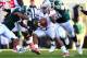 September 29, 2012; East Lansing, MI, USA; Ohio State Buckeyes quarterback Braxton Miller (5) is tackled by Michigan State Spartans cornerback Johnny Adams (5) and nose tackle Anthony Rashad White (98) during the second half of a game at Spartan Stadium. Ohio State won 17-16. Mandatory Credit: Mike Carter-US PRESSWIRE