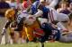 BATON ROUGE, LA - OCTOBER 08: Spencer Ware #11 of the Louisiana State University Tigers is tackled by Jelani Jenkins #3 of the Florida Gators and Josh Evans #24 of the Florida Gators at Tiger Stadium on October 8, 2011 in Baton Rouge, Louisiana. (Photo by Chris Graythen/Getty Images)