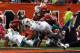 CINCINNATI, OH - OCTOBER 07: Running back Daniel Thomas #33 of the Miami Dolphins scores a touchdown as he dives past defenders Vontaze Burfict #55 and Nate Clements #22 of the Cincinnati Bengals at Paul Brown Stadium on October 7, 2012 in Cincinnati, Ohio. (Photo by Matt Sullivan/Getty Images)