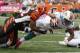 Oct 7, 2012; Cincinnati, OH, USA; Miami Dolphins running back Daniel Thomas (33) falls into the end zone for a touchdown against Cincinnati Bengals cornerback Nate Clements (22) during the second quarter at Paul Brown Stadium. Mandatory Credit: David Kohl-US PRESSWIRE