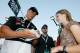 CONCORD, NC - MAY 26: Professional wrestler John Cena signs an autograph on pit road prior to the NASCAR Busch Series CARQUEST Auto Parts 300 on May 26, 2007 at Lowe's Motor Speedway in Concord, North Carolina. (Photo by Kevin C. Cox/Getty Images)