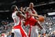 ATLANTA, GA - JANUARY 16: Jeff Teague #0 of the Atlanta Hawks drives against Amir Johnson #15 and Jose Calderon #8 of the Toronto Raptors at Philips Arena on January 16, 2012 in Atlanta, Georgia. NOTE TO USER: User expressly acknowledges and agrees that, by downloading and or using this photograph, User is consenting to the terms and conditions of the Getty Images License Agreement. (Photo by Kevin C. Cox/Getty Images)