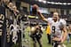 NEW ORLEANS, LA - OCTOBER 07: Drew Brees #9 of the New Orleans Saints smiles as he leaves the field after a 31-24 win over the San Diego Chargers in which Brees broke the record for consecutive games with a touchdown pass setting the new mark at 48 games at Mercedes-Benz Superdome on October 7, 2012 in New Orleans, Louisiana. (Photo by Harry How/Getty Images)